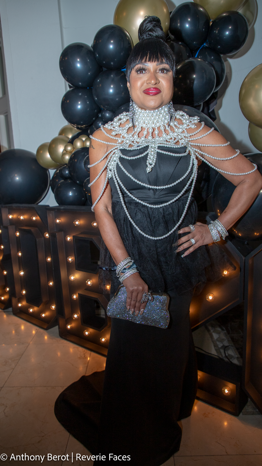 Guest in a black gown with pearl jewellery at the Black Diamond Ball.